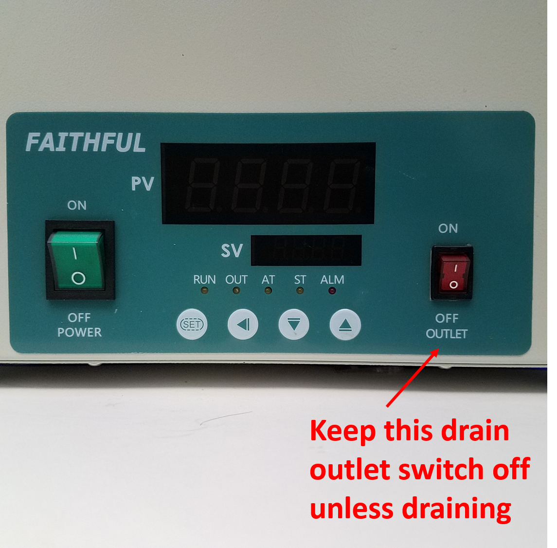 Close-up of Faithful water bath control panel with digital display, power switch, and a warning to keep the drain outlet switch off.