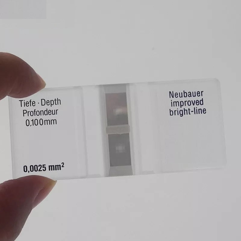 Handheld view of the Labnique Improved Neubauer Hemocytometer showing etched specifications for 0.100mm depth and 0.0025mm2 small square area.