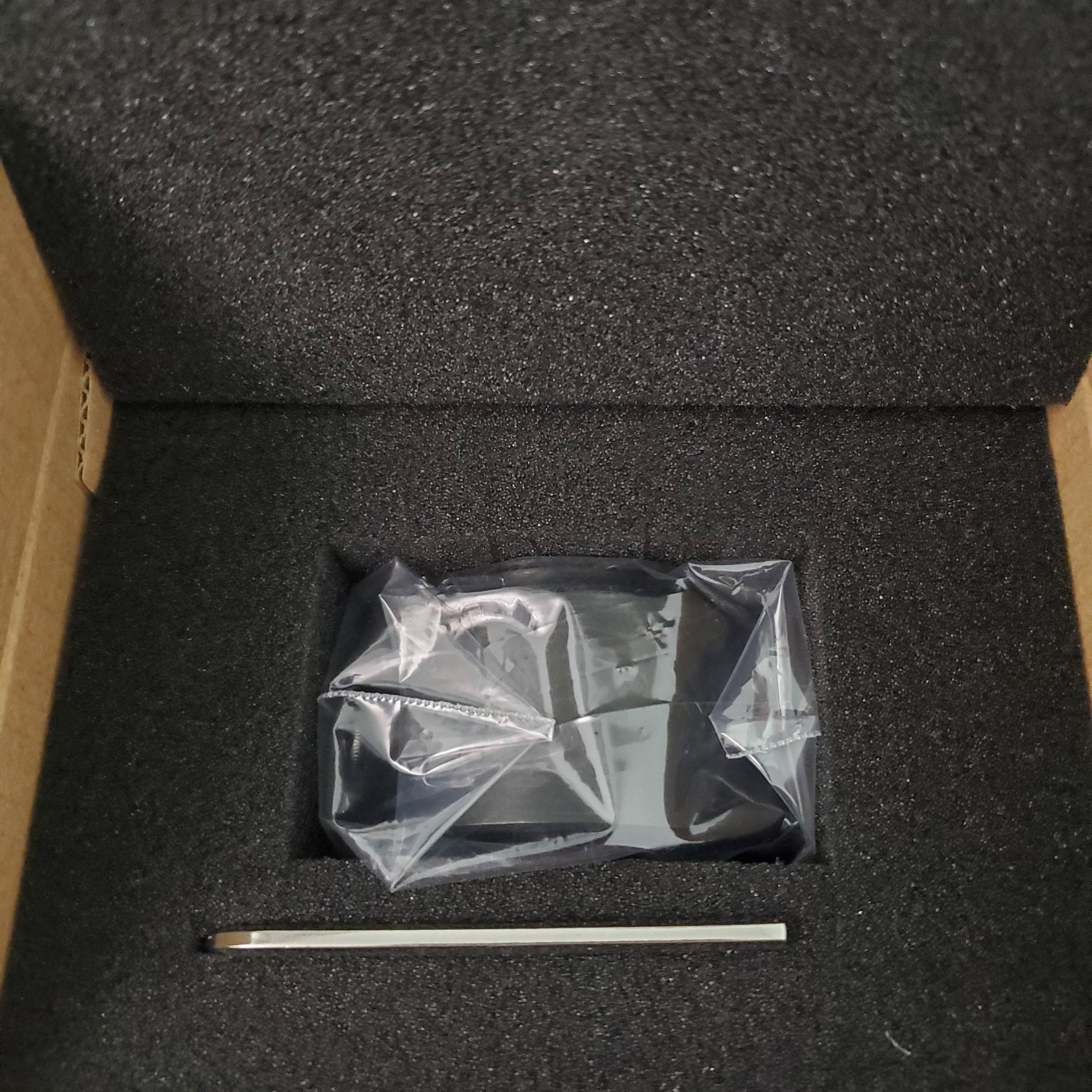Olympus 0.5x camera adapter kit in a protective storage box with included hex key for focus adjustment.