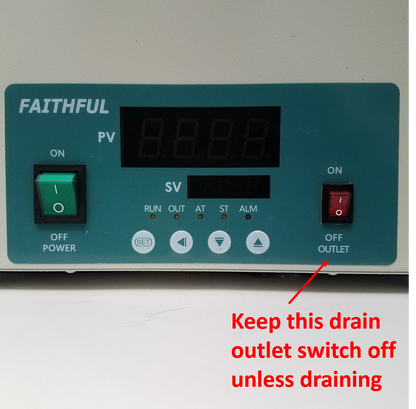 Close-up of Faithful water bath control panel with digital display, power switch, and a warning to keep the drain outlet switch off.